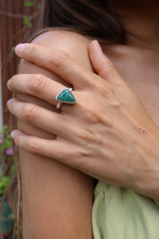 Green chrysoprase hammered sterling silver ring close-up—natural gemstone band, texture detail.
