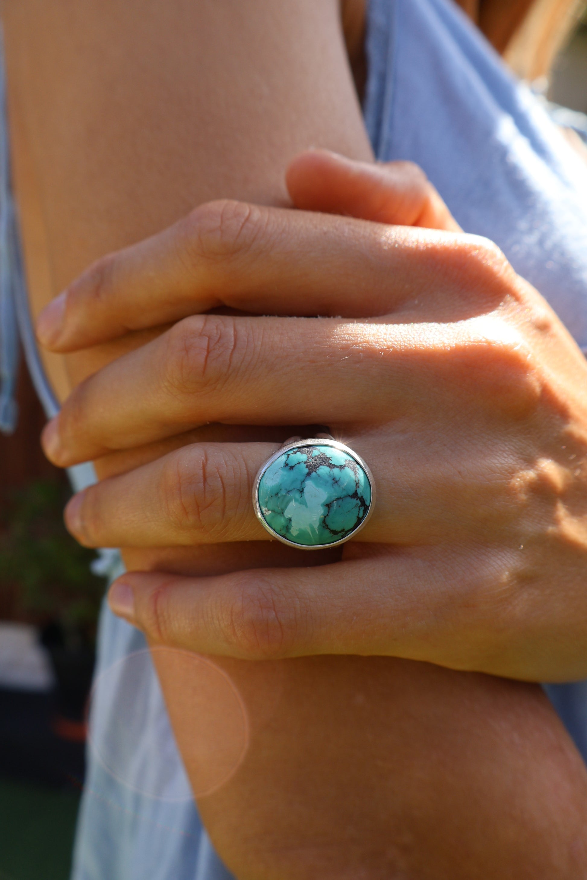 Close-up of Hubei Tibetan turquoise gemstone ring worn on hand